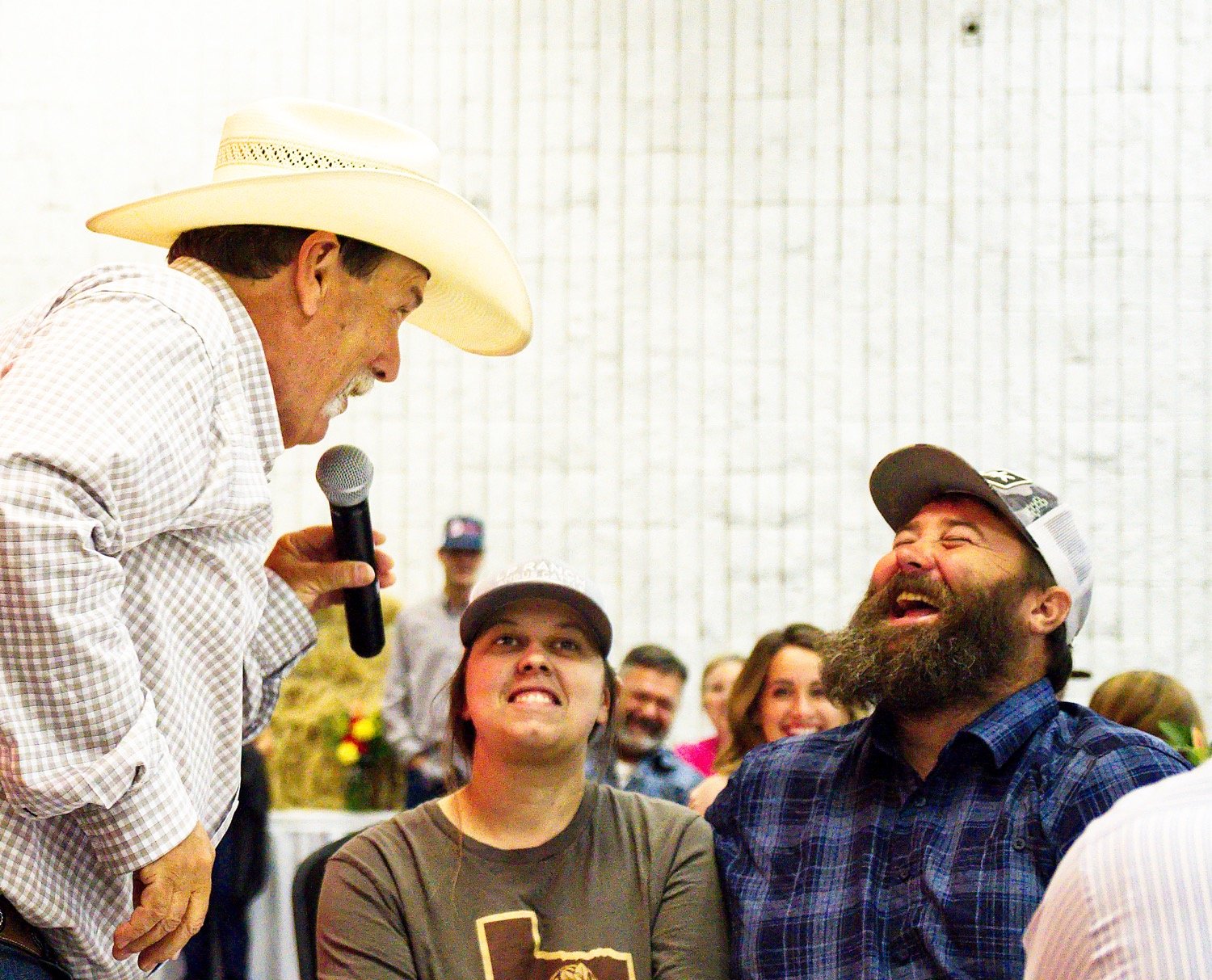 Kelly Conley (left) auctions off the thermal hog hunt offered by Trey Huff (right). [more hay auction action]